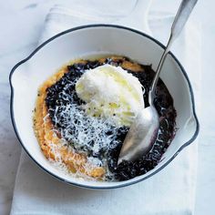 a bowl filled with black beans and ice cream on top of a white table cloth