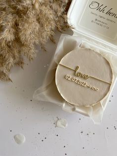 a personalized bracelet in a gift box next to some dried flowers and a teddy bear