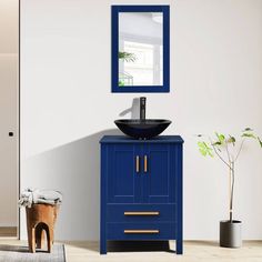 a bathroom with a sink, mirror and blue cabinet in the corner next to a potted plant