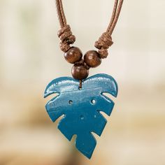 The vitality and magical energy of the Costa Rican forests inspire a bewitching design that captures the essence of the tropical jungle. Artisan Kattia López uses a calabash gourd to create the leaf pendant that adorns this unique necklace, painting it in a graceful blue hue that symbolizes wisdom. As a way to enrich the design's natural aura, Kattia adds pinewood beads to the brown cord and finishes the accessory with a convenient sliding knot that can be adjusted to your liking. Necklace Painting, Calabash Gourd, Gift Suggestions, Costa Rican, Earring Ideas, Sliding Knot, Unique Necklace, Leaf Pendant, Jewelry Packaging