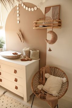 a room with a white dresser and brown chair