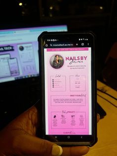 a person holding up a cell phone in front of a computer screen with the name nailby on it