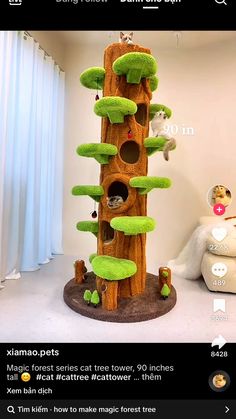 the cat tree is made out of wood and has green moss growing on it's sides