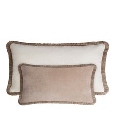 two pillows on top of each other with white and brown trim around the edges, one in