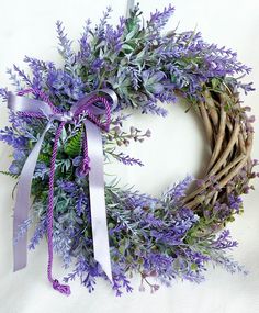 a wreath with purple flowers tied to it