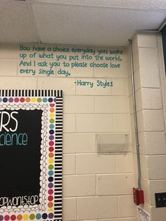 there is a chalkboard with writing on it in the corner of a classroom room