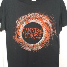 New/Unworn - Cannibal Corpse T-Shirt - Size Small. 2018 3 Decades Of Tour Print. Standard Unisex Crew Neck, Short Sleeve T-Shirt With Graphic Print Front And Back. Gildan Heavy Cotton 100% Cotton. Black Band Logo Merch Shirt, Black Band Logo Shirt, Black Band Logo Shirt For Summer, Alternative Black T-shirt For Festivals, Alternative Black T-shirt For Festival, Alternative Black Festival T-shirt, Black Alternative Style T-shirt For Festivals, Black Shirt With Band Logo For Summer, Alternative Style Black Shirt For Fan Merchandise