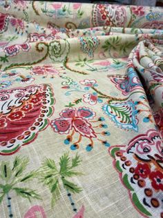 the fabric is very colorful and has an intricate pattern on it's surface,