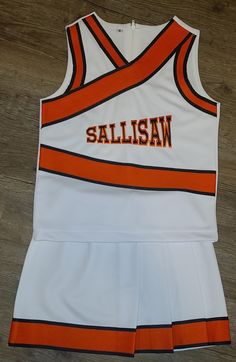 an orange and white basketball uniform with the word sallisan on it's chest