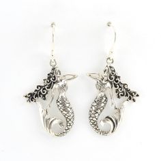 These intricate mermaid dangle earrings are handmade with sterling silver in Bali. Dangle earrings are 1 9/16 inches long and 3/4 inch wide. Earrings come with a pair of clear rubber earring stoppers for the ear wires. Style Number: 16023 Metal: 925 Sterling Silver Dimensions: 1 9/16 inches long and 3/4 inch wide Handmade in Bali, Indonesia Whimsical Sterling Silver Dangle Earrings, Whimsical Sterling Silver Pierced Earrings, Whimsical Sterling Silver Jewelry With Matching Earrings, Whimsical Nickel-free Sterling Silver Jewelry, Whimsical Dangle Jewelry With Matching Earrings, Whimsical Sterling Silver Earrings, Nickel Free Whimsical Drop Earrings, Whimsical Dangle Jewelry With Lobster Clasp, Whimsical Sterling Silver Drop Earrings