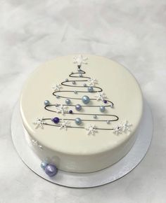 a white cake with a decorated christmas tree on it