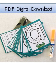 a bunch of cards and markers sitting on top of a white surface with a marker next to them