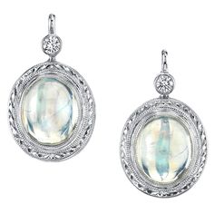 Once in a Blue Moon! Very fine quality moonstone cabochons are featured in these beautiful earrings. These moonstones are highly transparent with fine blue adularescence or "billowing light" effect, which gives moonstone its mysterious nature. Each moonstone is bezel set in a beautifully hand engraved, 18k white gold mounting, accented with a sparkling diamond. Handmade by our Master Jewelers in Los Angeles. This design is what we call our "go-to" style, as they are suitable for wearing any time Engagement Earrings, Moonstone Earrings, Diamond Drops, Diamond Drop Earrings, Lovely Jewellery, Fine Earrings, Screw Back Earrings, Earrings Dangle, Sparkle Diamonds