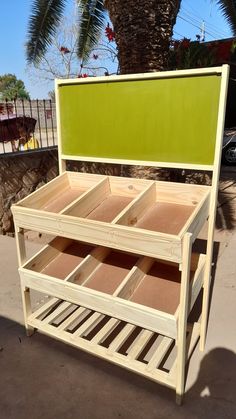 a green headboard and foot board with drawers on it in front of a palm tree