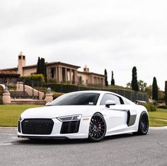 a white car parked in front of a house