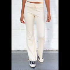 Soft Cotton Blend Tie Yoga Pants With A Big Flare Pant Leg. Fabrics: 100% Cotton Measurement: 10" (30 Cm) Rise, 34" (81 Cm) Inseam, 15" (66 Cm) Waist (Stretches) Made In: Italy Chic Fitted Straight Sweatpants, Fitted Athleisure Sweatpants, Fitted Straight Chic Sweatpants, Chic Fitted Sweatpants Trousers, Chic Fitted Straight Leg Sweatpants, Sporty Wide Leg Fitted Pants, Fitted Sweatpants With Elastic Waistband, Chic Fitted Sweatpants For Spring, Fitted Wide-leg Sweatpants For Loungewear