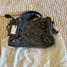 100% Authentic Balenciaga City Bag In Anthracite With Rose Gold Giant Hardware. Comes With Original Dust Bag. The Lamb Skin Leather Is Buttery Soft And The Anthracite Color Is A Slate Color With A Green Undertone. The Leather Has Softened Beautifully And Has Achieved The Signature Balenciaga City Slouch In Excellent Mint Condition, No Blemishes To The Leather Or Hardware. Slight Scratches On The Pocket Mirror. Balenciaga Mini City Bag, Balenciaga Mini City, Balenciaga Bag City, Balenciaga Hourglass Bag Silver, Silver Balenciaga Bag, Balenciaga Purse, Balenciaga Classic City Bag, Balenciaga Classic City, Balenciaga Motorcycle Bag Brown