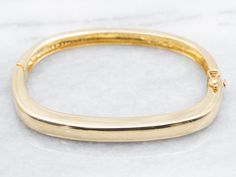 This elegant bangle bracelet is the perfect addition to any jewelry collection. Crafted with yellow gold, the hinged design allows for easy wear and adds a touch of sophistication to any outfit. A must-have accessory for any fashion-forward individual! Metal: 18K Yellow Gold Width: 5.5 mm Inside Circumference: 6 Inches Marks: "18K" Stamped on the inside SKU #: A42970 Each piece has been identified and graded by a Graduate Gemologist who has been certified by the Gemological Institute of America Bangle Stacking, 18k Gold Bangle, Bangle Bracelet Gold, Pocket Watch Chain, Stacked Bangles, Watch Chain, Gold Bangle Bracelet, Gold Bangle, Hinged Bangle