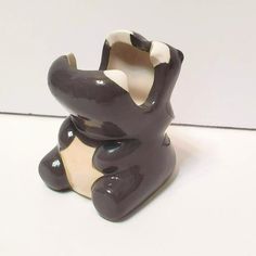 a small ceramic animal sitting on top of a white table