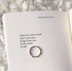 an open book with a ring on it