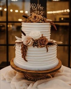 a white wedding cake with flowers on top