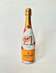 a bottle of wine that is sitting on a white tablecloth with an image of a flamingo painted on it