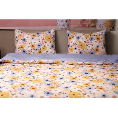 an image of a bed with flowers on the comforter and pillow cases in different colors