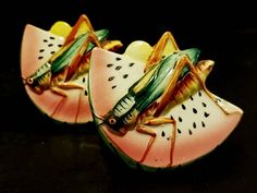 two figurines of grasshoppers on slices of watermelon