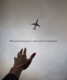 a person's hand reaching up towards an airplane in the sky with a quote above it