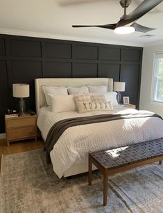 a bedroom with a large bed and ceiling fan