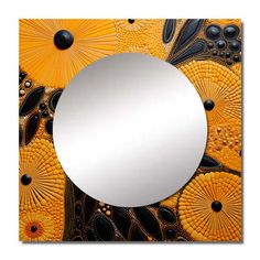 a mirror that is sitting on top of a wooden table with an orange and black design