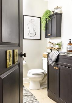 a white toilet sitting in a bathroom next to a black and white checkered floor