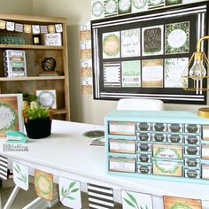 a desk with many cards on it and a potted plant