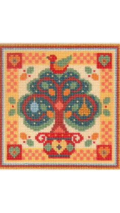 a cross stitch rug with an image of a tree on it