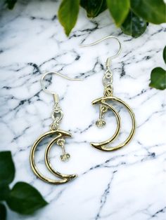 Crescent moon Dreamland Earrings 🌙 Free shipping! The moons have a slight rose gold tone, although they look pretty close to silver as well. They come with silver earring hooks, but I'm happy to add on gold hooks instead! Send me a message & let me know if you have a preference. Crafted with love 💖   Thank you for checking out LunaeLumina!  Feel free to message me if you have any questions! Silver Crescent Cartilage Earrings With Moon Charm, Gold Moon Phase Earrings, Gold Moon-shaped Metal Hoop Earrings, Gold Moon Shaped Metal Hoop Earrings, Gold Moon Shaped Hoop Earrings, Dainty Moon Charm Earrings, Gold Moon-shaped Earrings With Moon Charm, Minimalist Silver Moon Phase Earrings, Silver Moon Shaped Cartilage Earrings