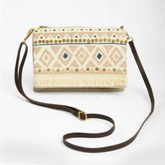 BOHO SLING BAG - LINEN AND OFF WHITEFabric - pure thick natural linen with off white cotton and fringe, matching cotton liningSling - Adjustable leather strap -1.5 mts length with clips to attach and detatchSize -  9 inch wide X 7 inch long Structure - 2 main compartments ;                     one compartment with ykk metal zip closure                     2nd compartment closes with embroidered flap with magnetic buttonA beautiful and unique bohemian bag in pure linen colour with off white cotto Cream Shoulder Bag Clutch With Adjustable Strap, Bohemian Beige Clutch Shoulder Bag, Beige Bohemian Clutch Shoulder Bag, Bohemian Cream Crossbody Bag, Cream Crossbody Canvas Bag, Bohemian Beige Satchel With Removable Pouch, White Bohemian Shoulder Bag With Adjustable Strap, Bohemian Beige Crossbody Shoulder Bag, Beige Bohemian Crossbody Shoulder Bag