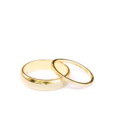 two gold wedding rings on a white background