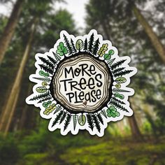 a sticker with the words more trees please on it in front of some trees