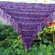 I have hand knitted this beautiful, plus size women hippie fairycore style, triangle wrap shawl with an assortment of luxury, multicolored and textured yarns and a purple sequin yarn in shades of dark purples and a touch of light lilac, raspberry, pinks and burnished gold. A wonderful cottagecore gifts idea! (Please be aware colors show differently on various devices) This multicolored shawl measures (without the wild and ragged fringe) approximately 180 cm across the top edge and 97 cm long dow Knitted Triangle, Bulky Scarf, Witchy Cottagecore, Ren Faire Costume, Cottagecore Gifts, Bohemian Wrap, Multicolor Knit, Fringe Shawl, Light Lilac