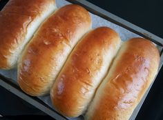 four loaves of bread sitting on top of a baking sheet