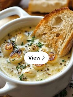 there is a bowl of soup with bread in it and the words view above it