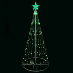 a lighted christmas tree in the dark with stars on top and green lights around it