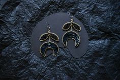 ❧  Statement black crescent moon earrings are entirely handmade, crafted from brass and glass beads. The design embodies the concept of naive art, boasting large, vibrant pieces that effortlessly draw attention, making a bold statement. ❧ Hypoallergenic steel earrings clasp! ❧ Size: the length is 3 inch / 7.5cm ❧ The jewelry piece will be delivered in stylish packaging and can be ready for gifting. An example of the packaging can be seen in the photo carousel. The packaging includes a craft box Half Moon Earrings, Celestial Earrings, Crescent Earrings, Gemstone Choker, Crescent Moon Earrings, Bohemian Handmade, Choker Pendant, Artisan Earrings, Red Gemstones