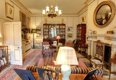 a living room filled with furniture and a fire place in the middle of a room