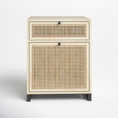 the side table is made out of rattan and has two drawers on each side