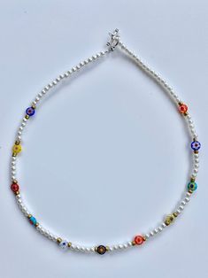 This gorgeous beaded necklace is made with a variety of millefiori beads, and pearl beads! Necklace measures 15  and 17 inches long! If you have any questions or concerns please feel free to message me and I'll try my best to get back to you ASAP Happy shopping!! Adjustable Multicolor Beaded Flower Necklace, Multicolor Flower-shaped Beaded Necklaces With Tiny Beads, Adjustable Flower-shaped Beaded Necklaces With Colorful Beads, Millefiori Bead Necklace, Blue Flower-shaped Beaded Necklaces With Colorful Beads, Natalie Martinez, Pearl Charm Necklace, Cute Necklace, Butterfly Charm