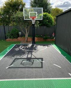 an outdoor basketball court in the backyard