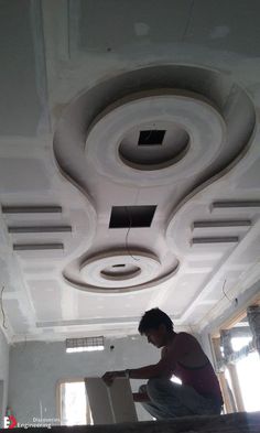 a man is working on the ceiling in an unfinished room that has been painted white