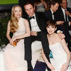 three people sitting next to each other at a party