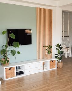 a living room filled with furniture and a flat screen tv on top of a wall